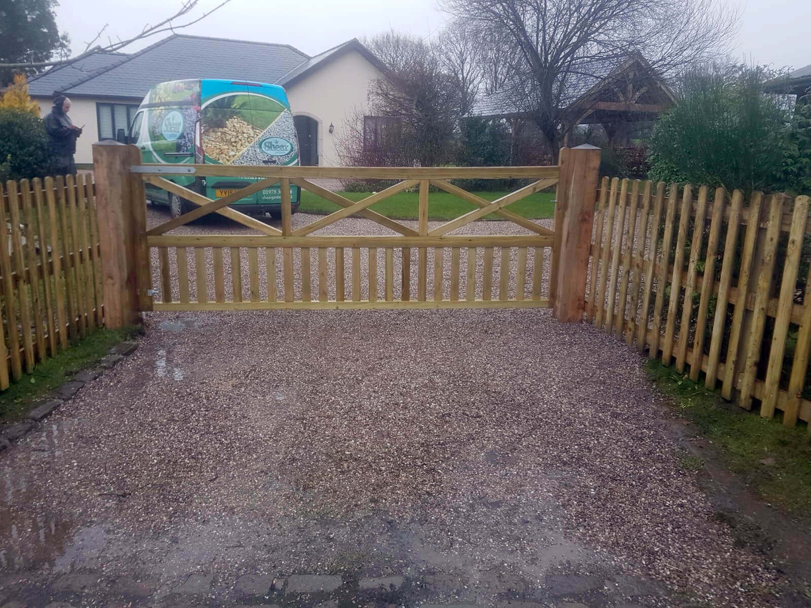 Wooden gates with palisade fencing