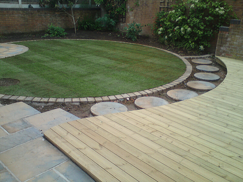 Curved landscape with deck and grass area